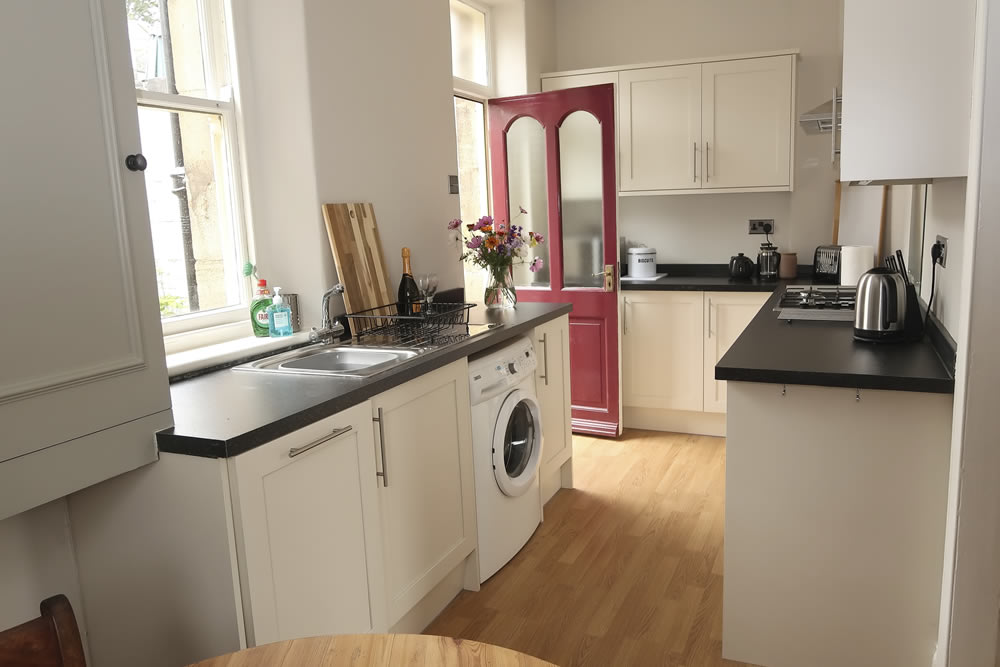 Generous worktop space, a built-in fridge, oven with gas hobs, extractor hood, microwave, dishwasher and washing machine